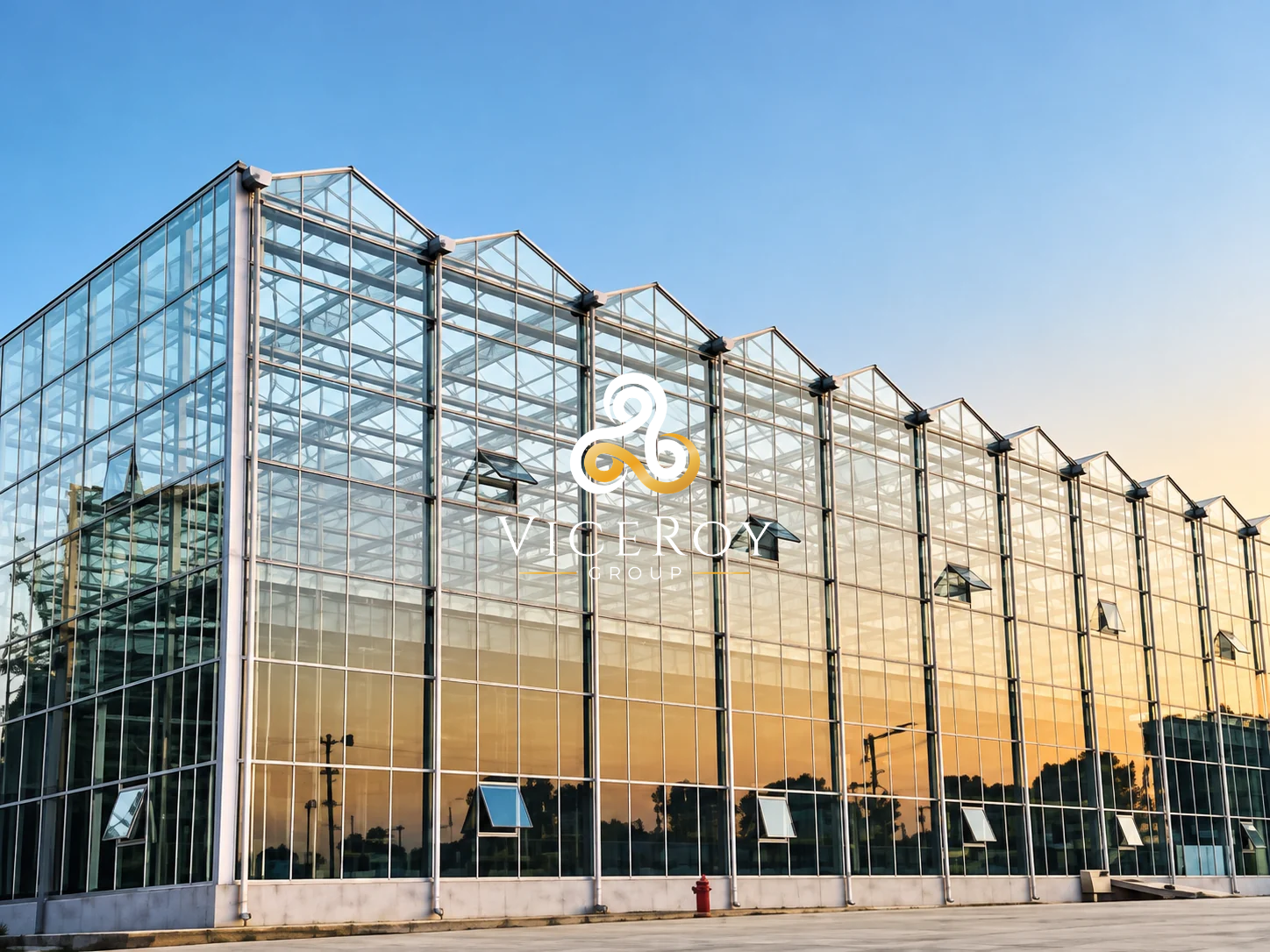 Illustrative rendering of HIPOTERM in Kochani: glazed greenhouse exterior in warm evening light